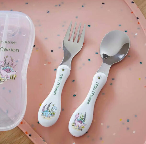 Mini Meirion dinosaur print fork and spoon set with matching storage case on a pink speckled background