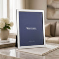 Whitehill Narrow Plain silver plated photo frame 10x8 inch displayed on marble surface with white hydrangeas - elegant tabletop easel frame in living room setting, Little Cutlery Australia