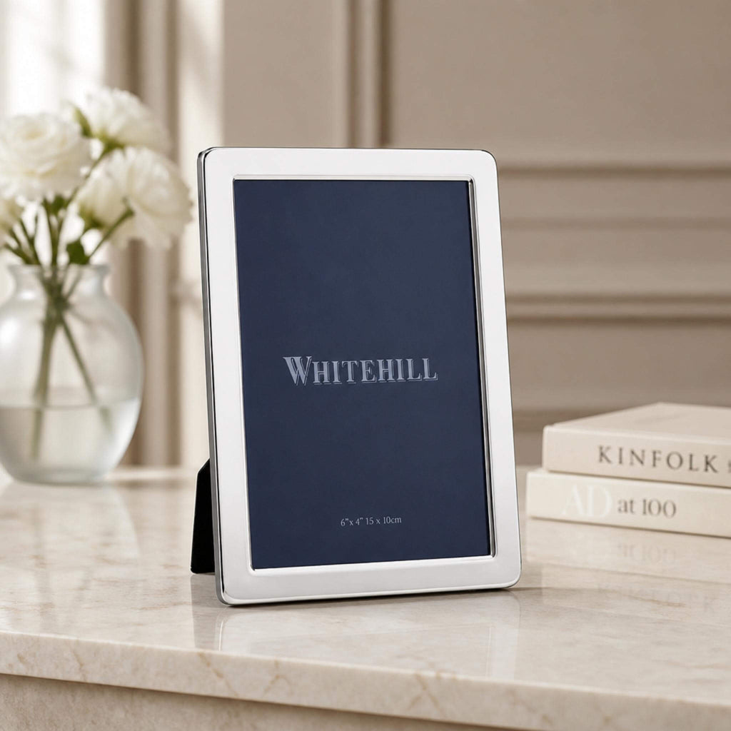 Whitehill Narrow Plain silver plated photo frame 6x4 inch displayed on marble surface with white roses - elegant tabletop easel frame in living room setting, Little Cutlery Australia