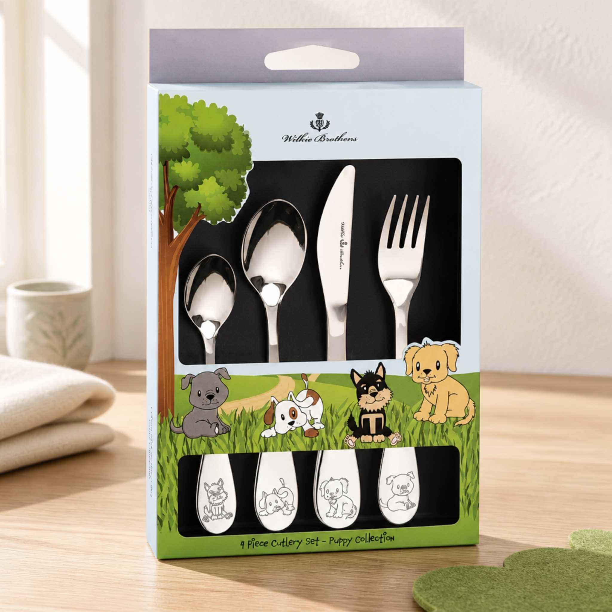 Wilkie Brothers Puppy Collection children's cutlery set 4 piece in gift box displayed on timber table - stainless steel kids cutlery with embossed puppy design, Little Cutlery Australia