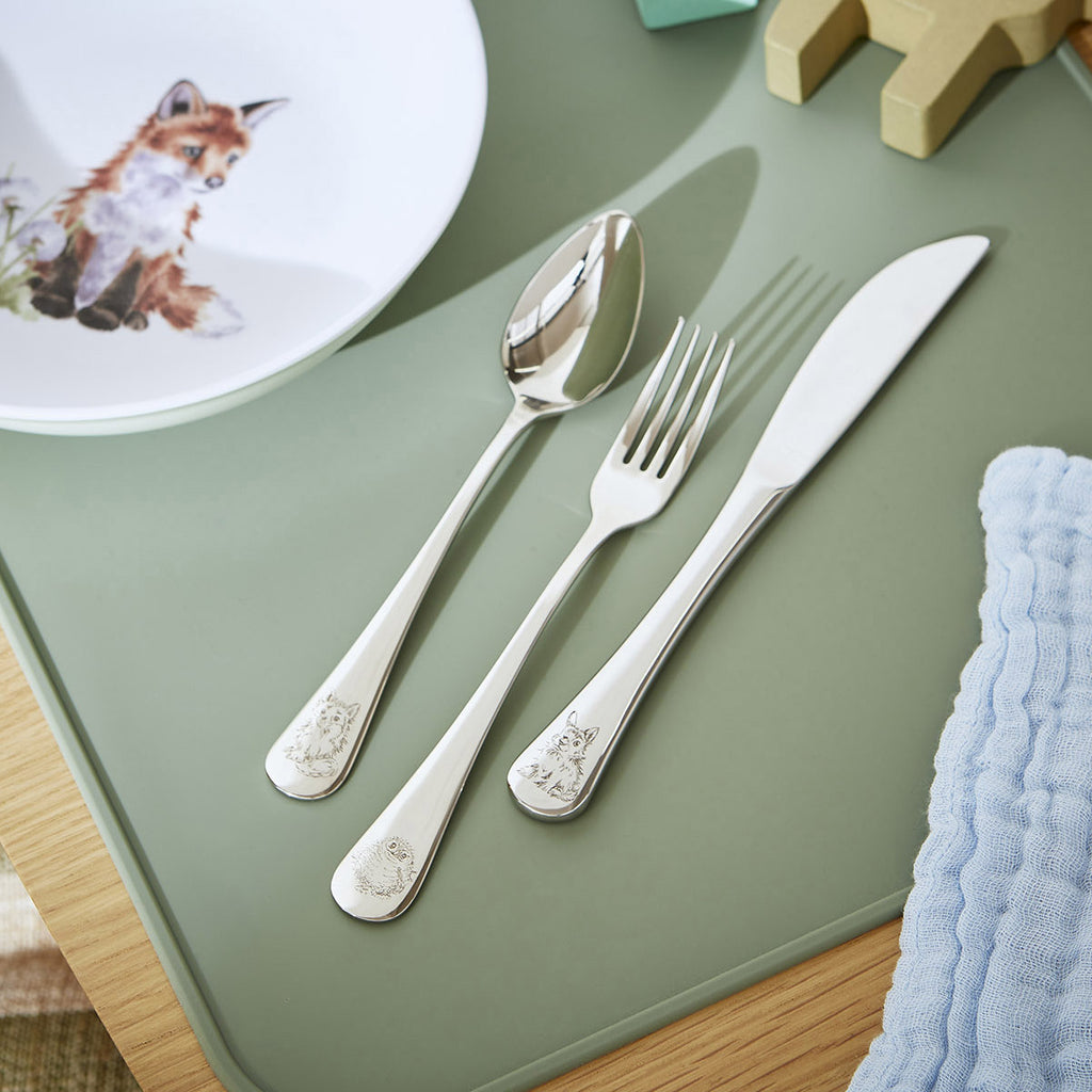 Royal Worcester Wrendale Designs Little Wren children's cutlery set 3 piece displayed on green placemat - stainless steel knife fork and spoon with woodland animal design, Little Cutlery Australia